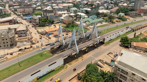 Aerial view of amawbia bridge spanning over bustling traffic and urban landscape, awka south, nigeria.