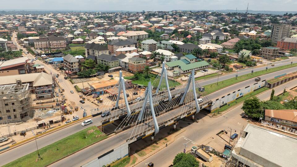 Aerial view of amawbia bridge spanning over bustling traffic and urban landscape, awka south, nigeria.