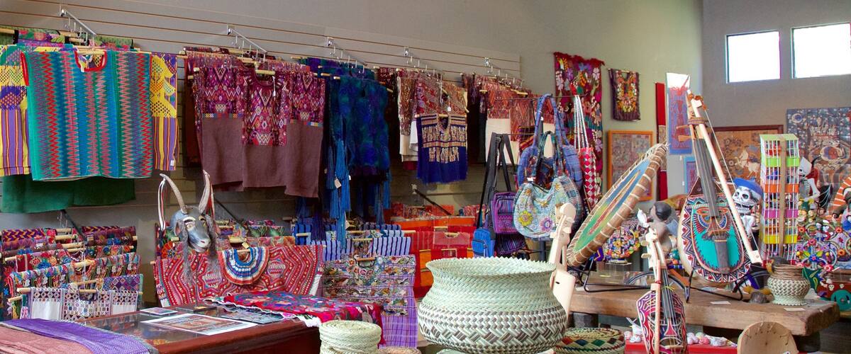 A variety of colorful textiles and woven baskets displayed in a shop.