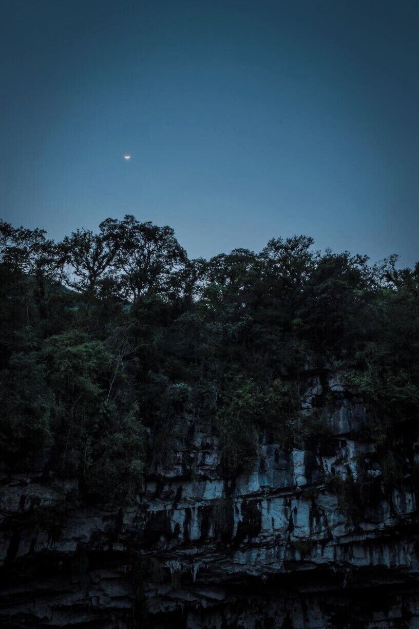 The moon setting over the famous Sótano de las Golondrinas, a natural abysm more than 500 meters deep, home to thousands of different kinds of birds.