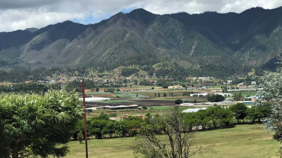 A mountainous landscape with a village nestled in the valley.