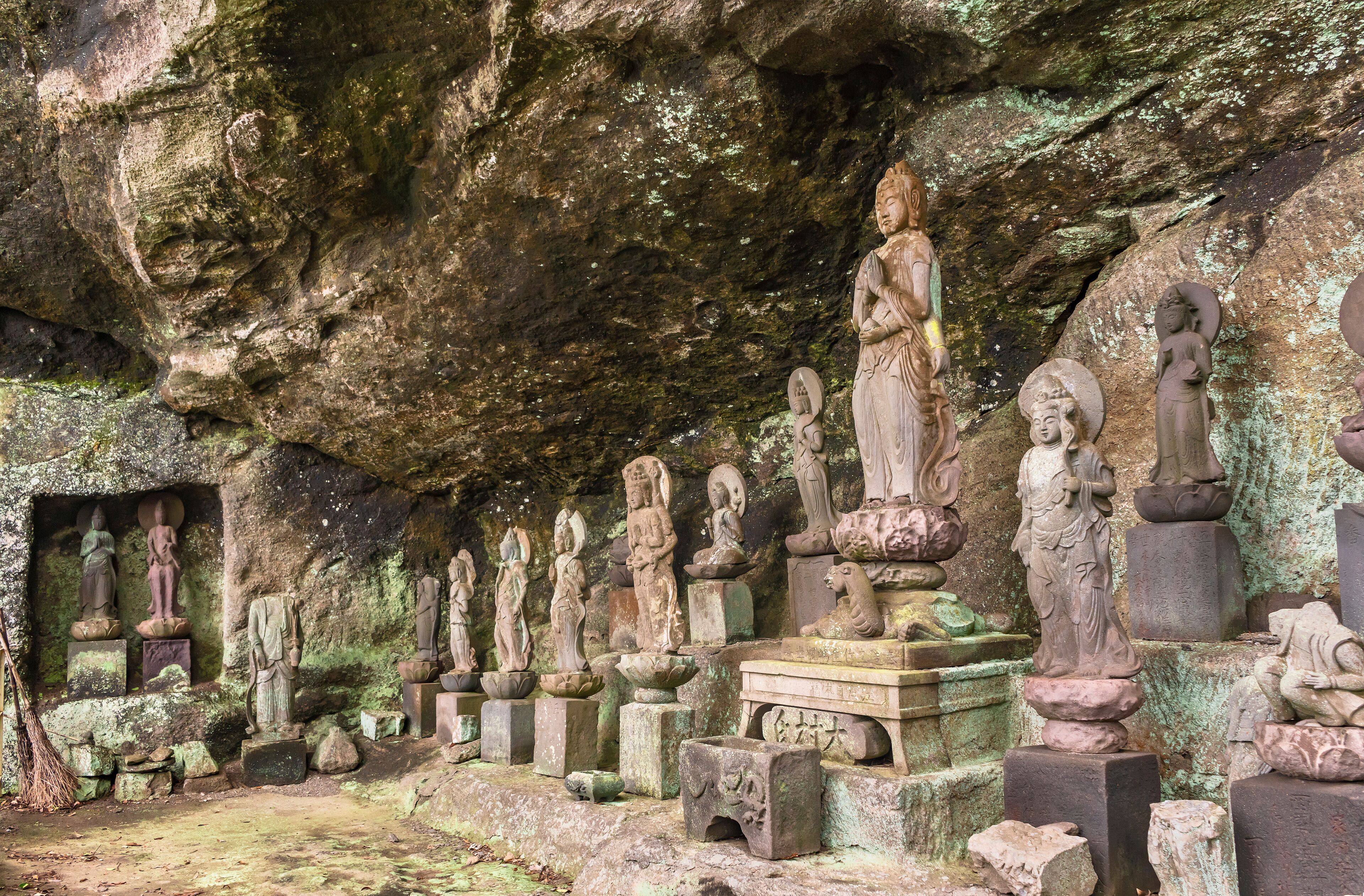 Buddhist statues of deities and monks surrounding the sculpture of Saigoku Kannon bodhisattva created in 18th century by Jingoro Eirei Ono in the Mount Nokogiri.