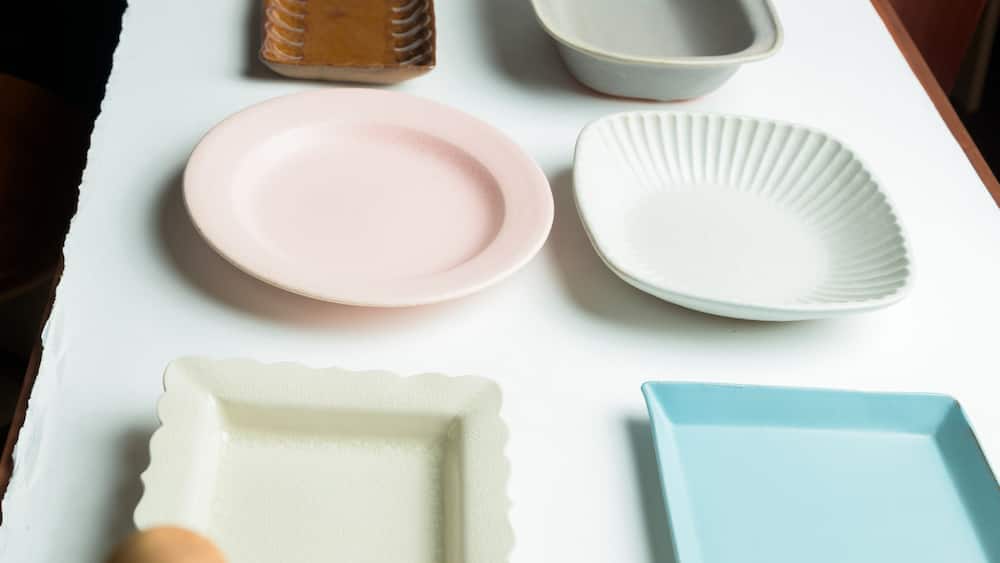 A collection of ceramic plates and bowls on a table.