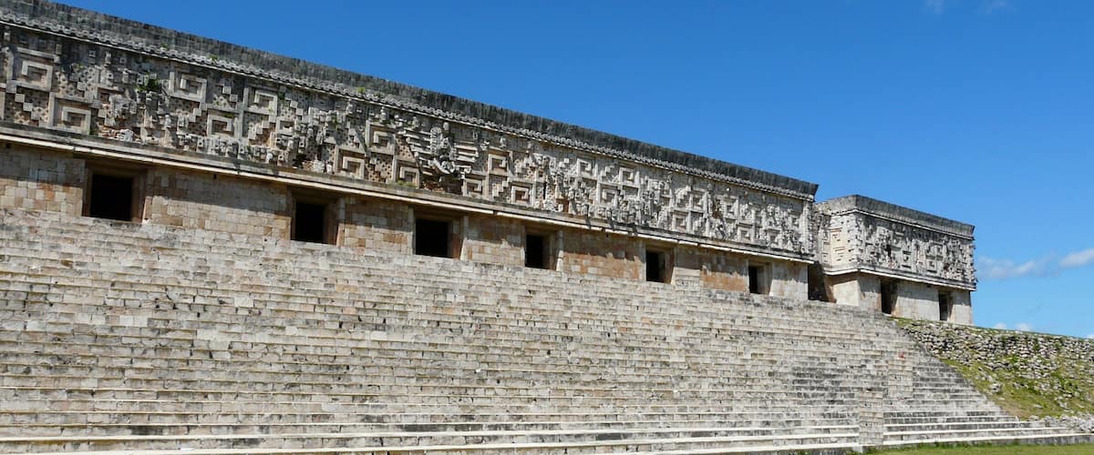 A large stone structure with intricate carvings and a stepped platform.
