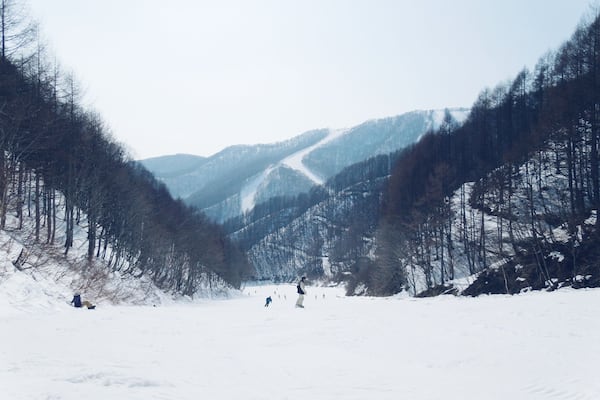 A snow-covered mountain landscape with a ski slope.
