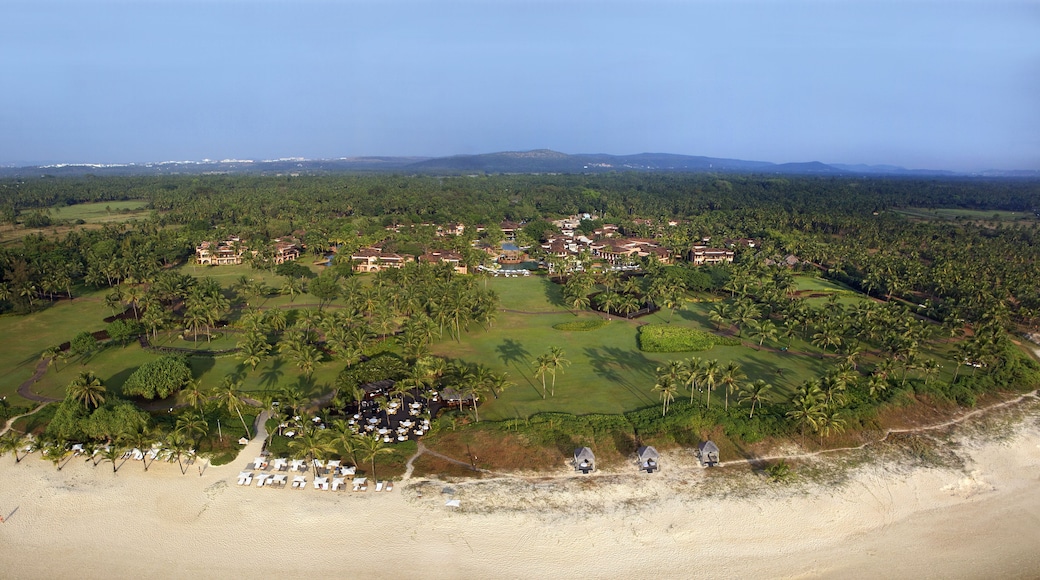 Bambolim, India - 17 November 2013: Aerial view of a luxurious resort nestled amidst lush green foliage, where terra-cotta roofs meet emerald lawns.