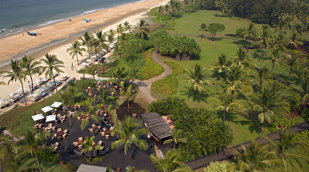 Bambolim, India - 19 November 2013: Aerial view of sun-kissed sands meeting emerald lawns, dotted with swaying palms and the inviting allure of a coastal resort.