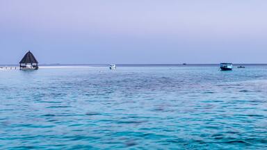 Turquoise water lagoon in the ocean. Coral reefs of the tropical island. Angaga, Maldives.