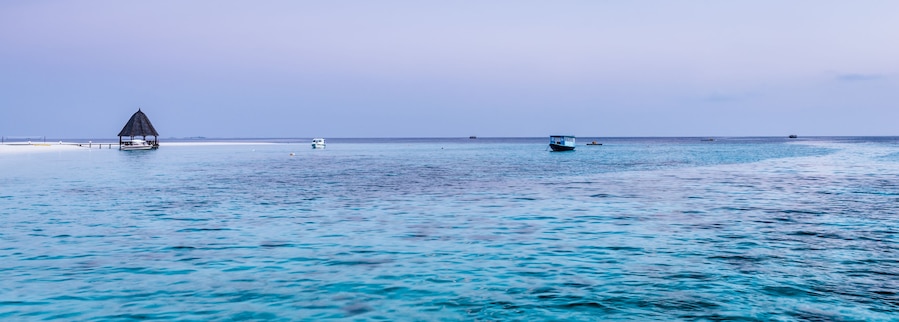 Turquoise water lagoon in the ocean. Coral reefs of the tropical island. Angaga, Maldives.