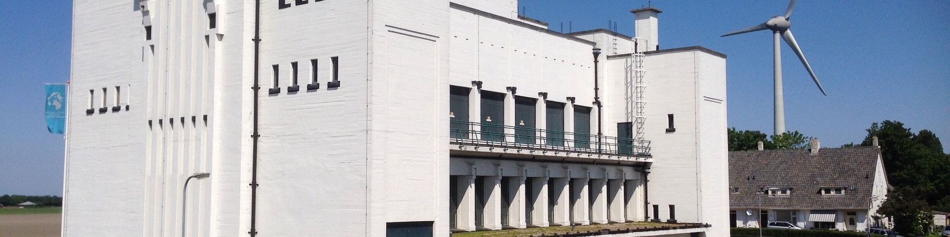 Seemingly random along the Dutch dikes you will find structures like this, which hide a pumping station. Named after Cornelis Lely, one of many who changed the Zuiderzee into the IJsselmeer. 
Many buildings are plain ugly by all possible definitions, this one is a nice exception. Style: New pragmatism. They are even more impressive when they engines are running. - No Holland without them! #greatdesign