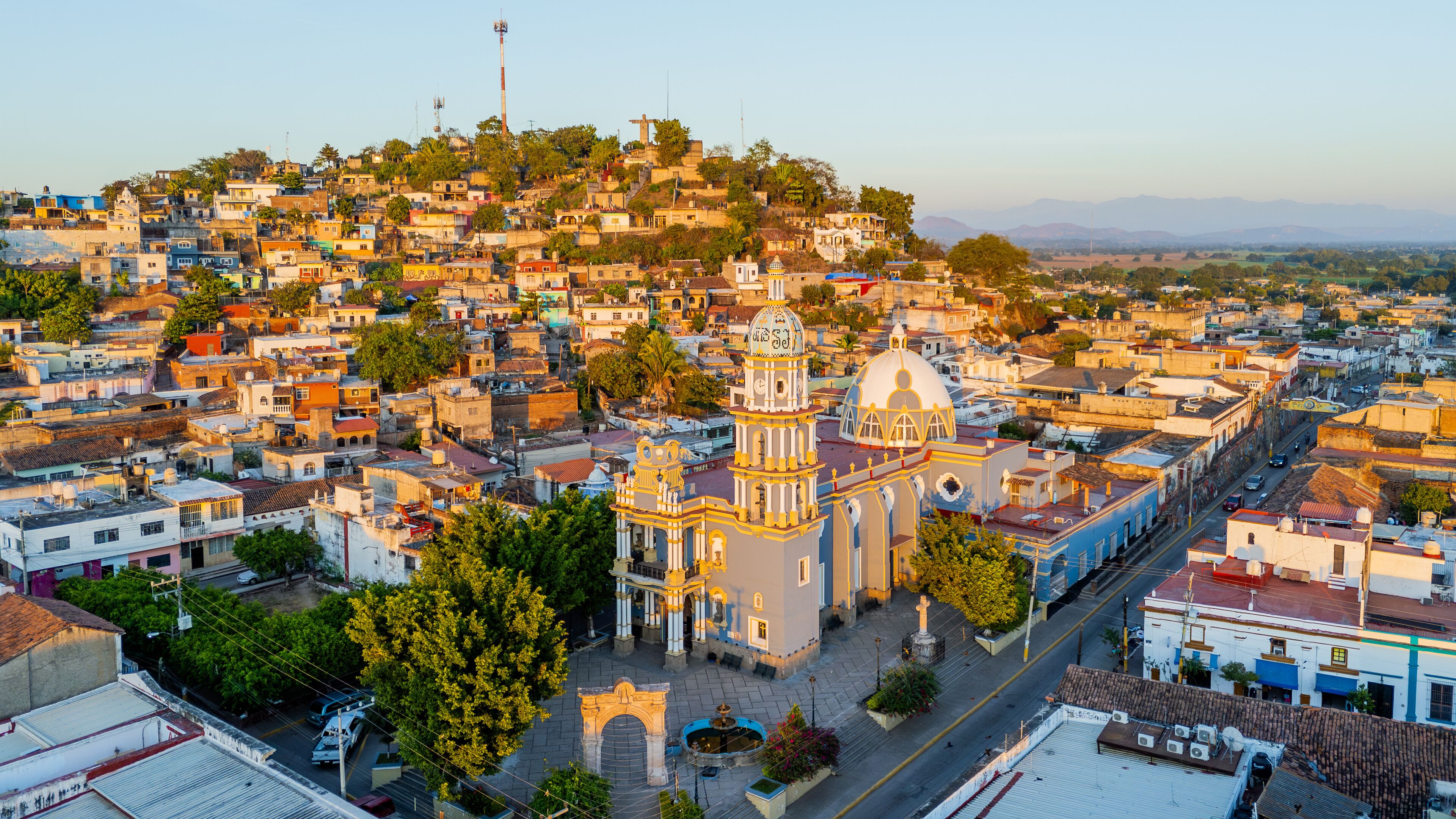 A densely packed urban area with a prominent church featuring a large dome and bell tower.