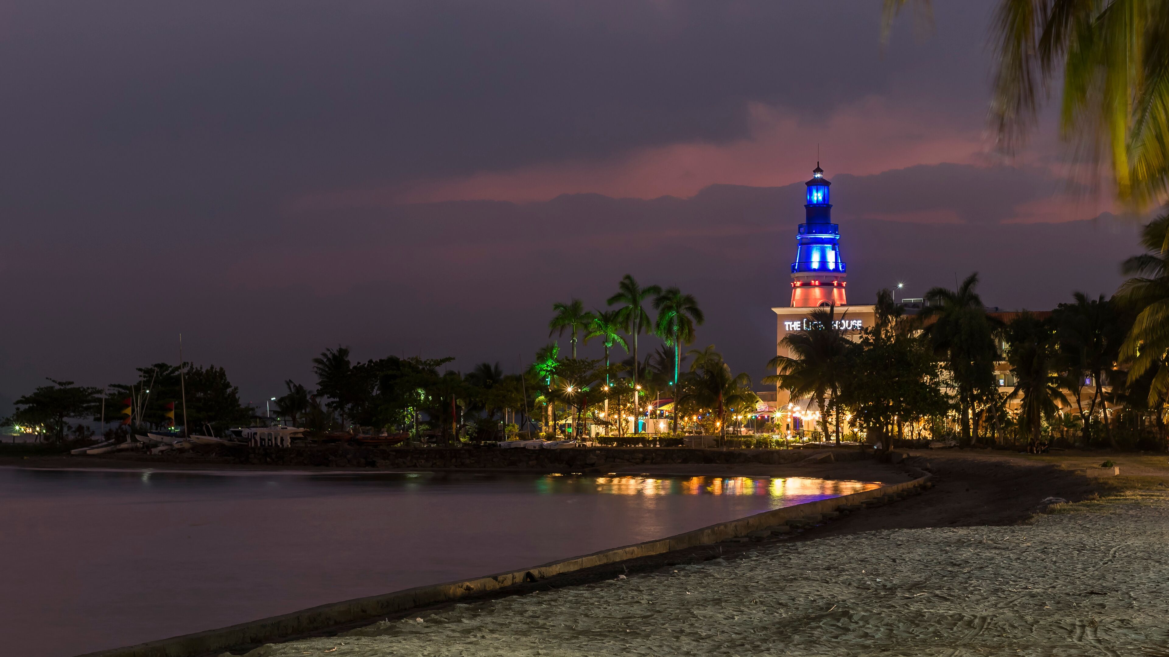 Subic, Philippines - SBMA Beach at sundown. The scenic Lighthouse Marina Resort lit at night.