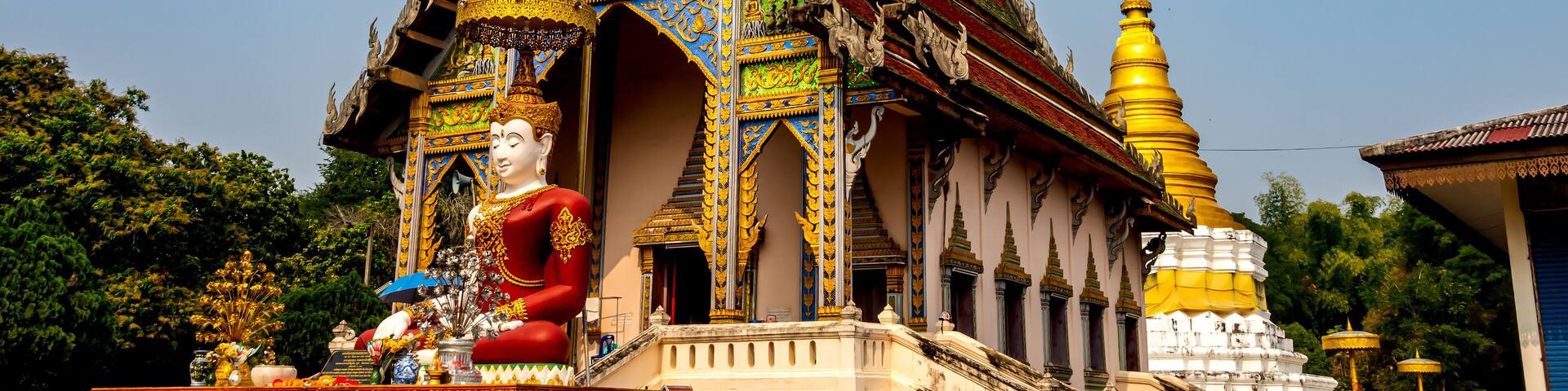 Wat Khu Kum, the ancient buddhist temple with the big Seated Buddha, the new main hall that build in April 27. 1972 /2515 and the Pagoda in Muang District, Lampang Province, Thailand.