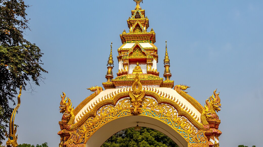 Decoration on the gate of Wat Khu Kum with the statues of Buddha, Naga, and Garuda in Muang District, Lampang Province, Thailand.