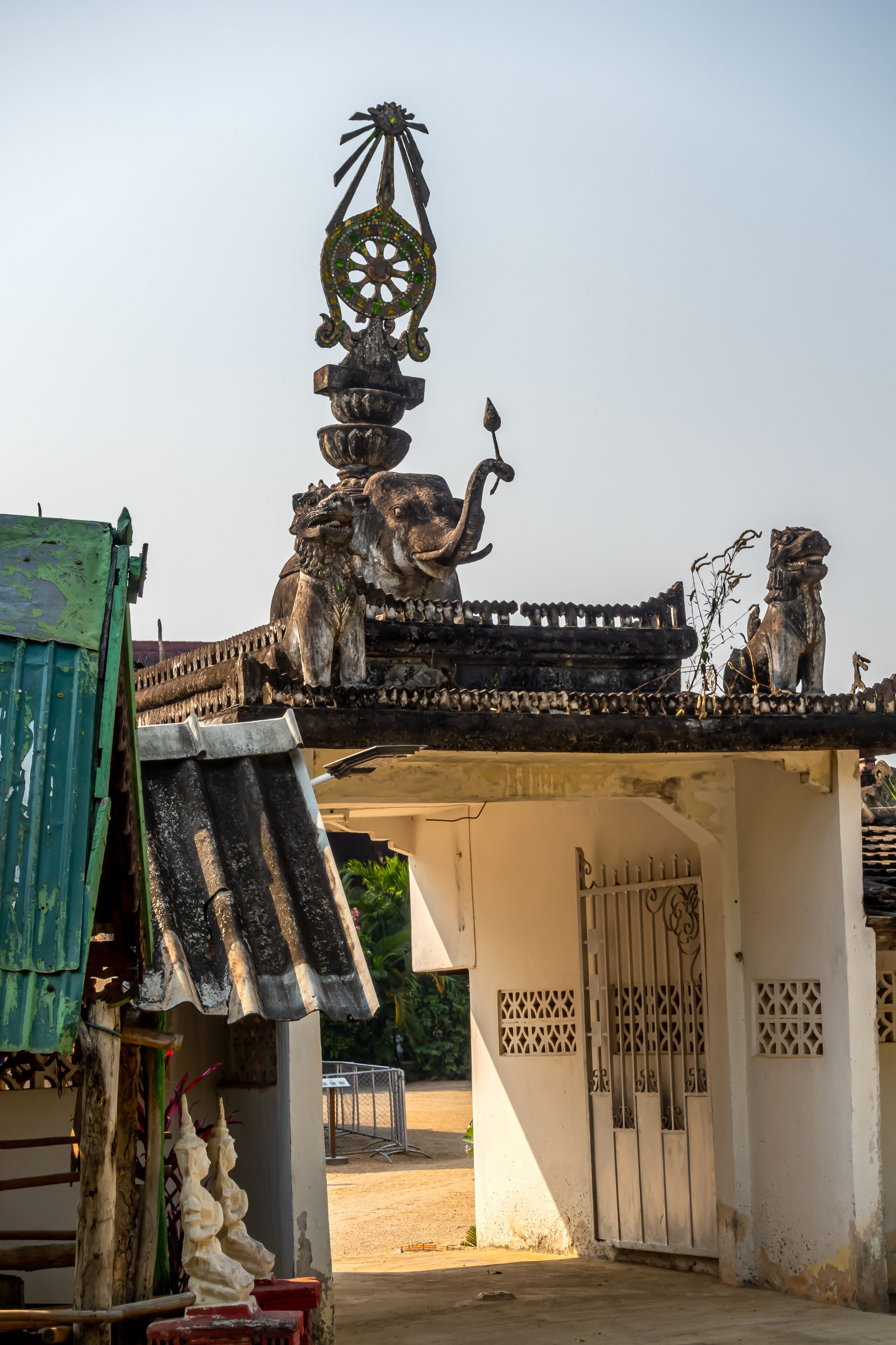 Decoration on the gate of Wat Khu Kum with the statues of Buddha, Naga, and Garuda in Muang District, Lampang Province, Thailand.