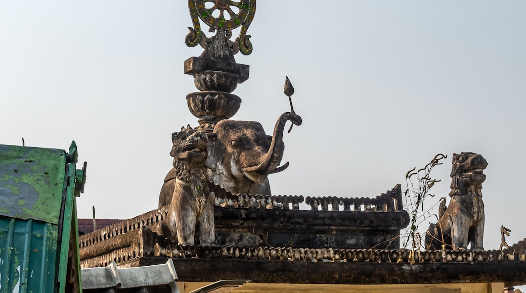 Decoration on the gate of Wat Khu Kum with the statues of Buddha, Naga, and Garuda in Muang District, Lampang Province, Thailand.