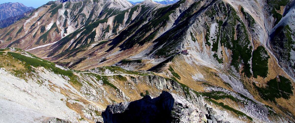 A mountain range with rugged peaks and a clear sky.