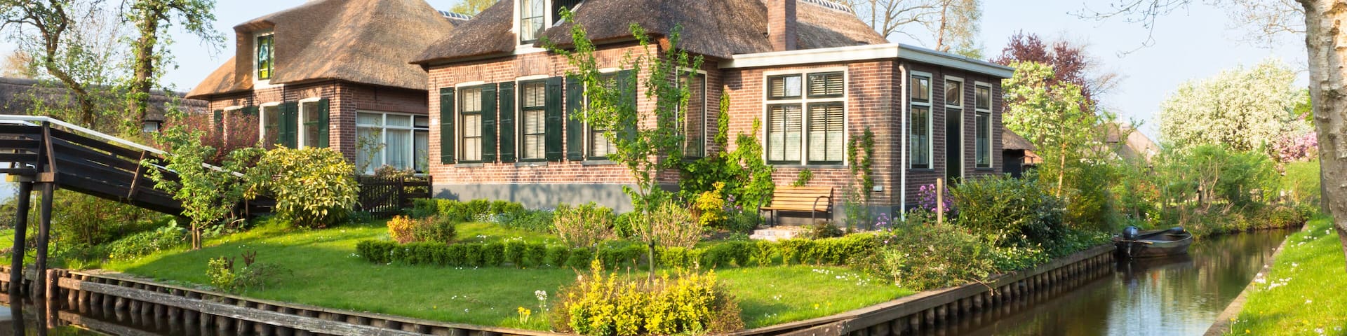 Beautiful traditional house with a thatched roof on a small island in a Dutch town of Giethoorn