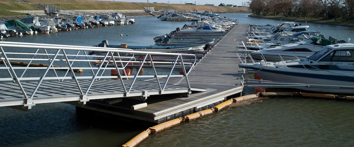 A marina with boats docked along a wooden pier.