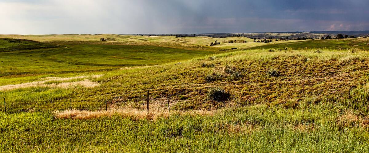 Sun Rays through Dark Summer Thunderstorms over the Northwestern Nebraska Grassland in the Summer as seen from Highway 20.