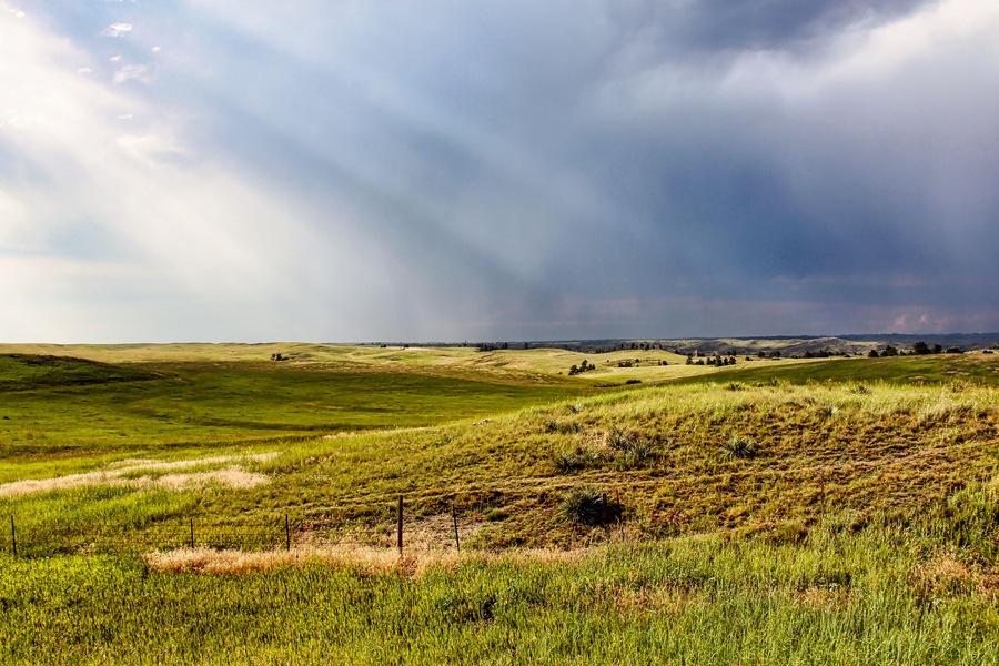 Sun Rays through Dark Summer Thunderstorms over the Northwestern Nebraska Grassland in the Summer as seen from Highway 20.
