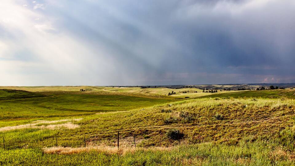 Sun Rays through Dark Summer Thunderstorms over the Northwestern Nebraska Grassland in the Summer as seen from Highway 20.