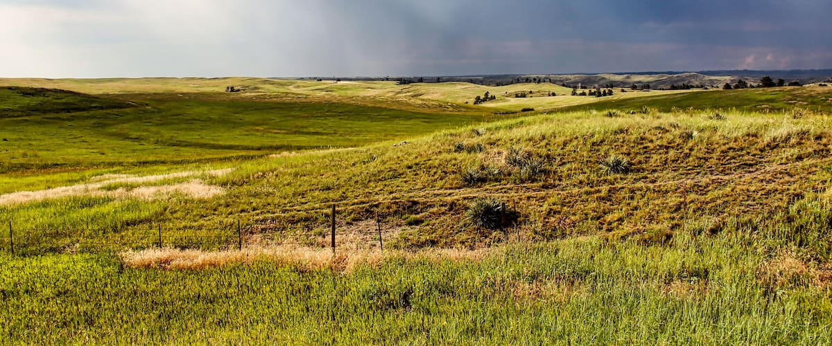 Sun Rays through Dark Summer Thunderstorms over the Northwestern Nebraska Grassland in the Summer as seen from Highway 20.