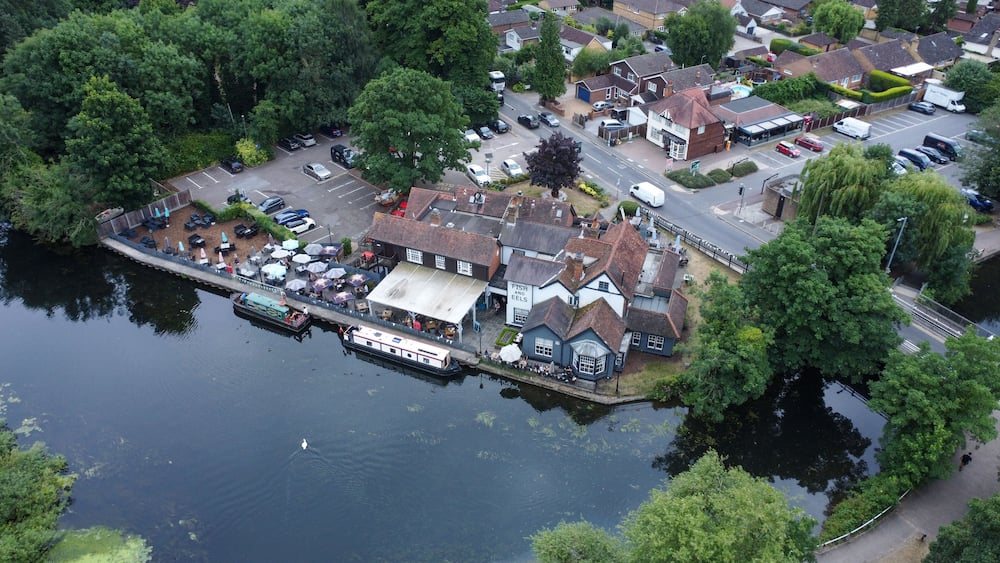 Aerial view of riverside pub and housing estate in Hoddesdon UK
