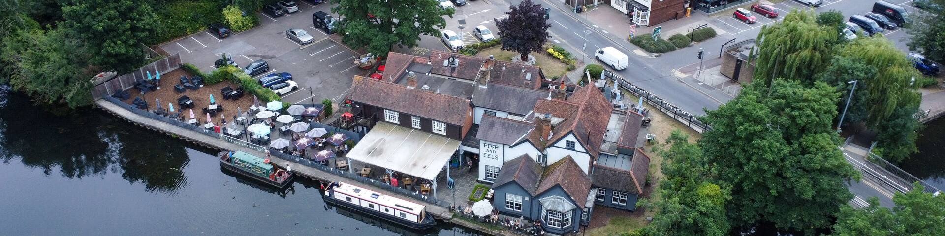 Aerial view of riverside pub and housing estate in Hoddesdon UK