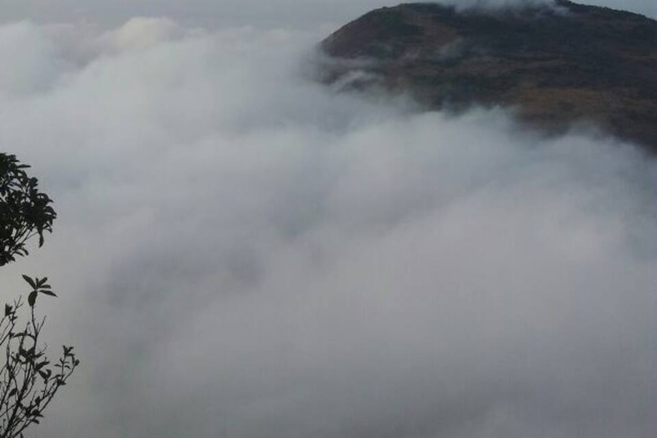 A mountain partially obscured by clouds.