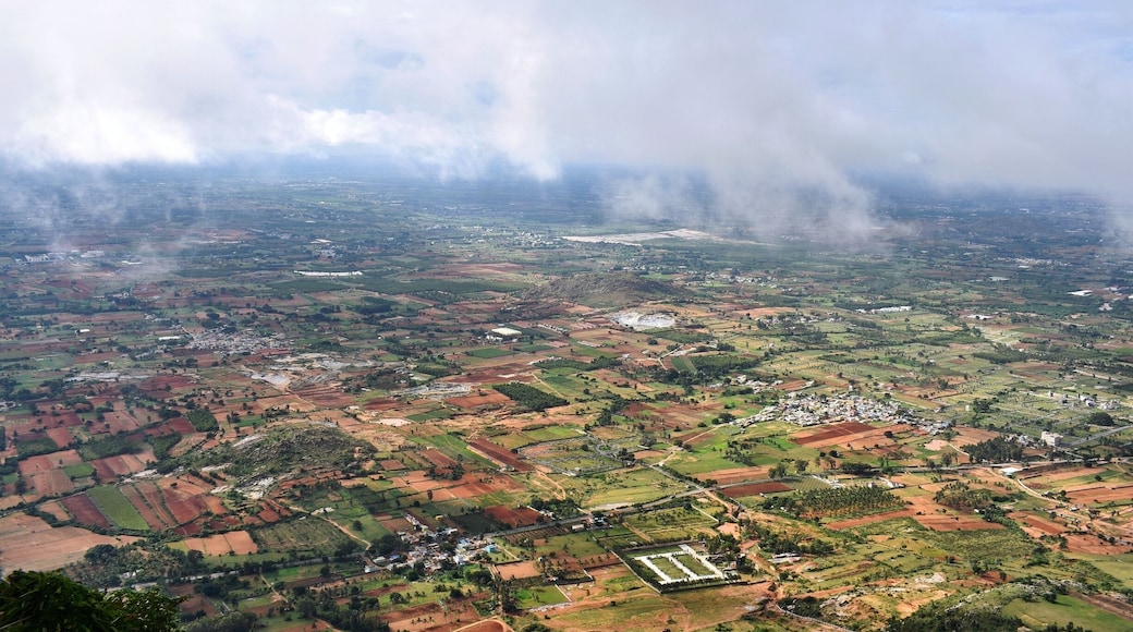 This is the beautiful view from atop Nandi Hill just when the sun clears up the clouds for a second. The clouds, greenery and the red fields make a colorful picture. #nandihills #sunriseviewpoint