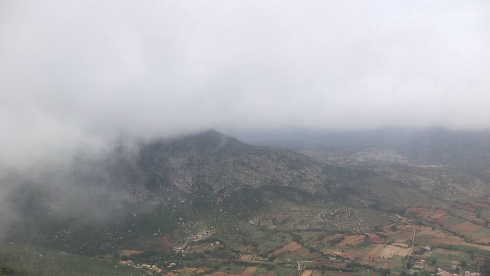 A mountainous landscape with fields and a village.