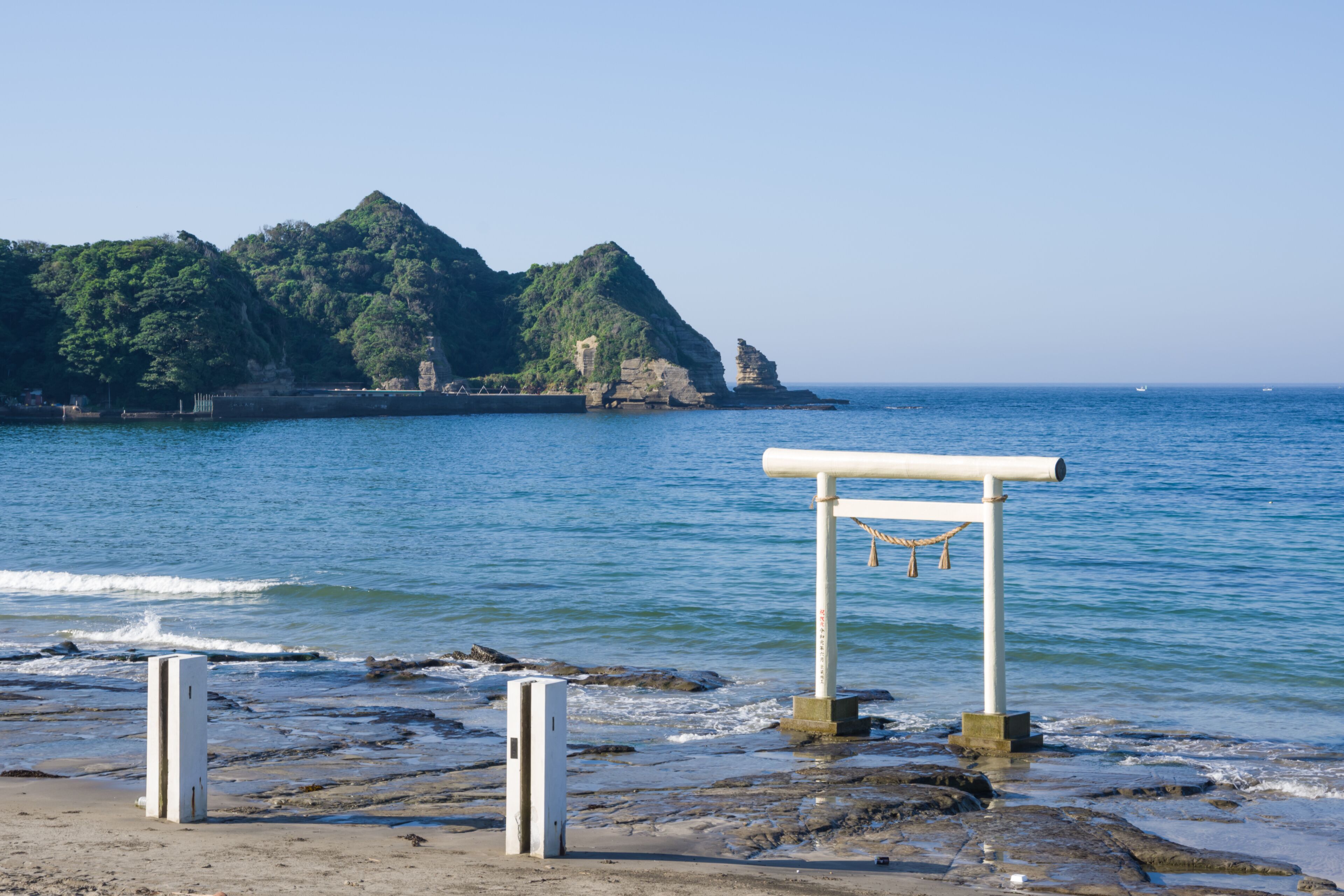 Ubara, Chiba, Japan , 09/01/2019 , Torii gate in Ubara beach.  it symbolically marks the transition from the mundane to the sacred.