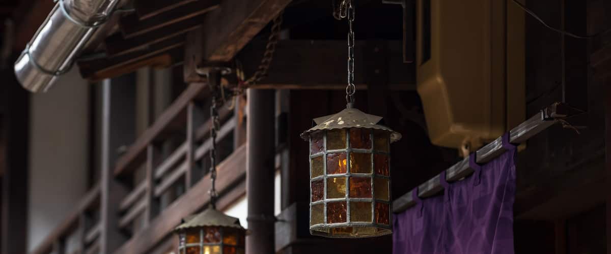 A building with hanging lanterns and purple fabric.