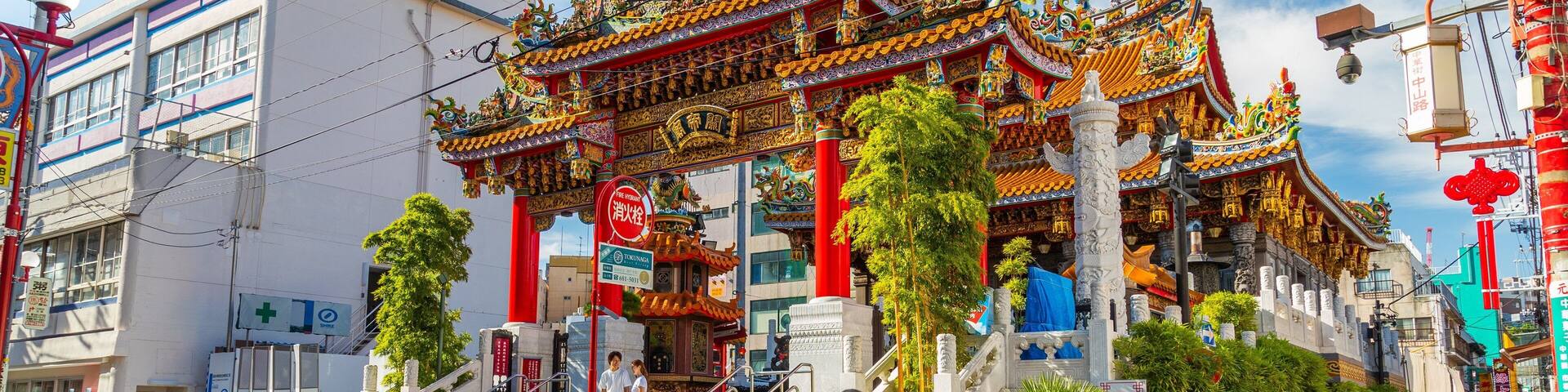A traditional temple with ornate architecture and a red entrance gate.