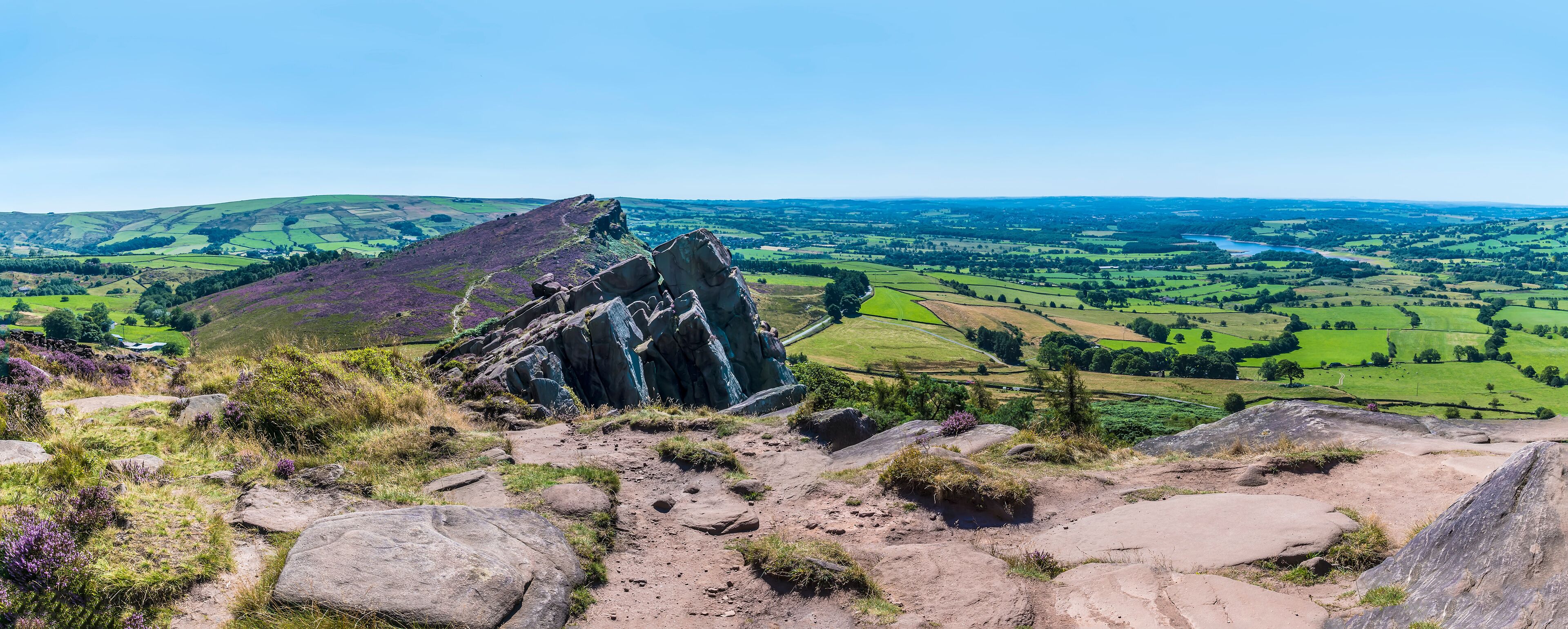 A panorama view across the summit of the Roaches escarpment, Hen Cloud and the Leek Valley, Staffordshire, UK in summertime