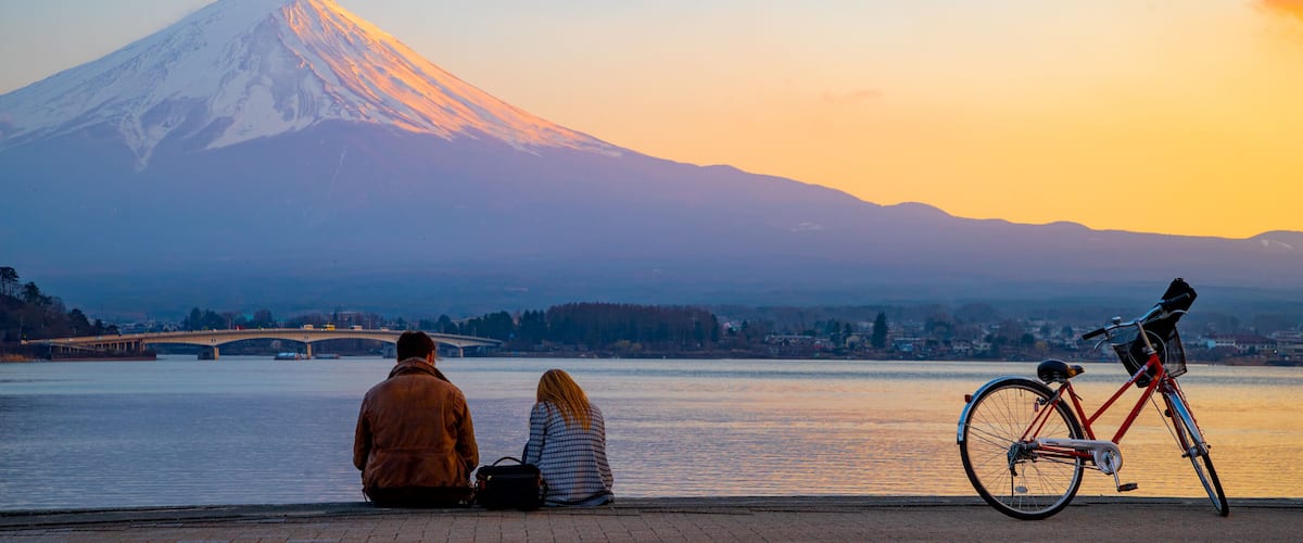 Lake Kawaguchi featuring mountains, a sunset and snow