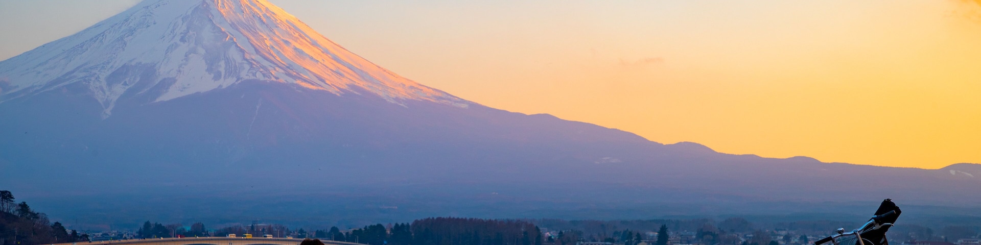 Lake Kawaguchi featuring mountains, a sunset and snow