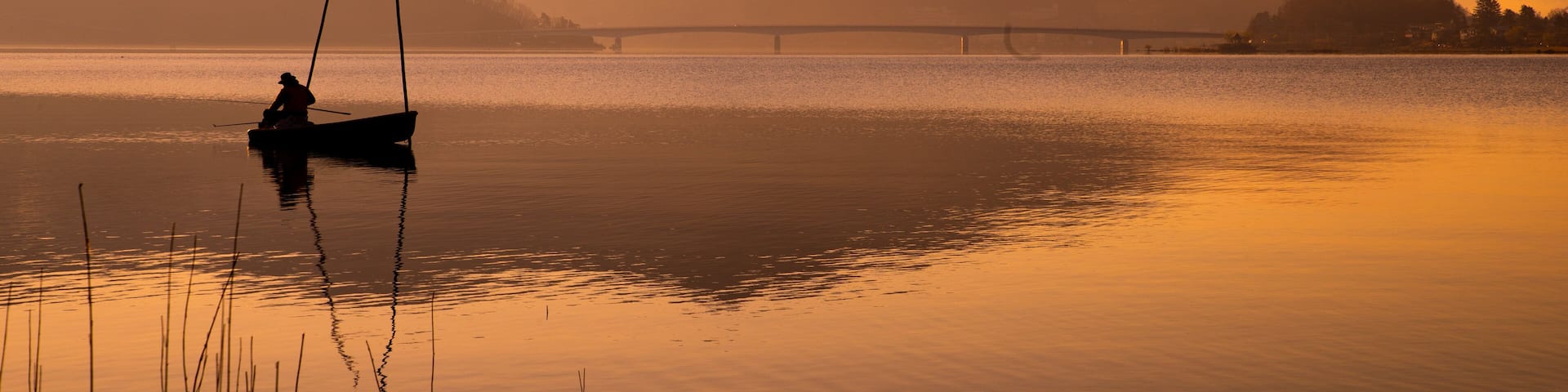 Lake Kawaguchi which includes fishing, a sunset and a lake or waterhole