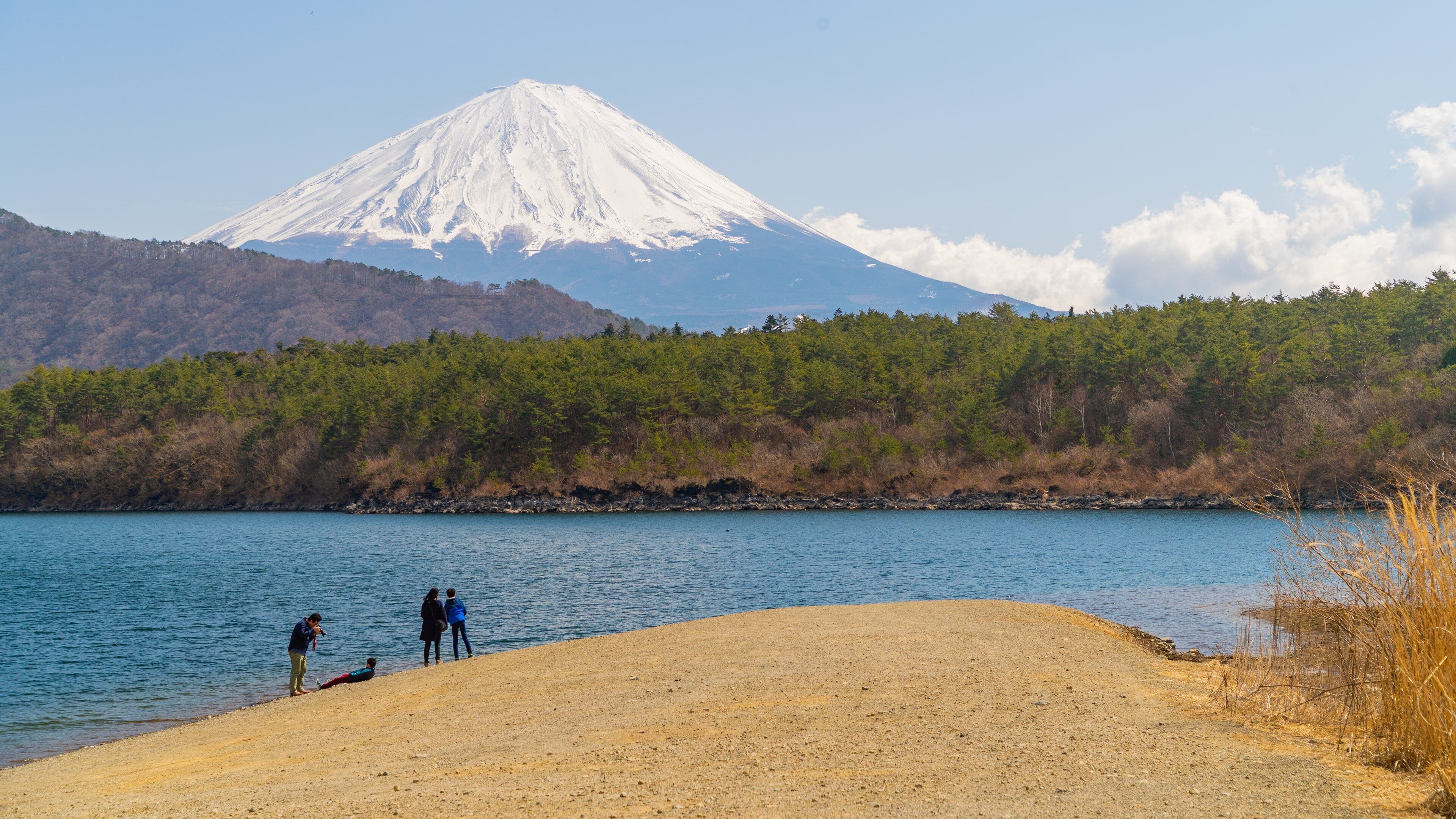 Lake Saiko featuring mountains, a lake or waterhole and snow