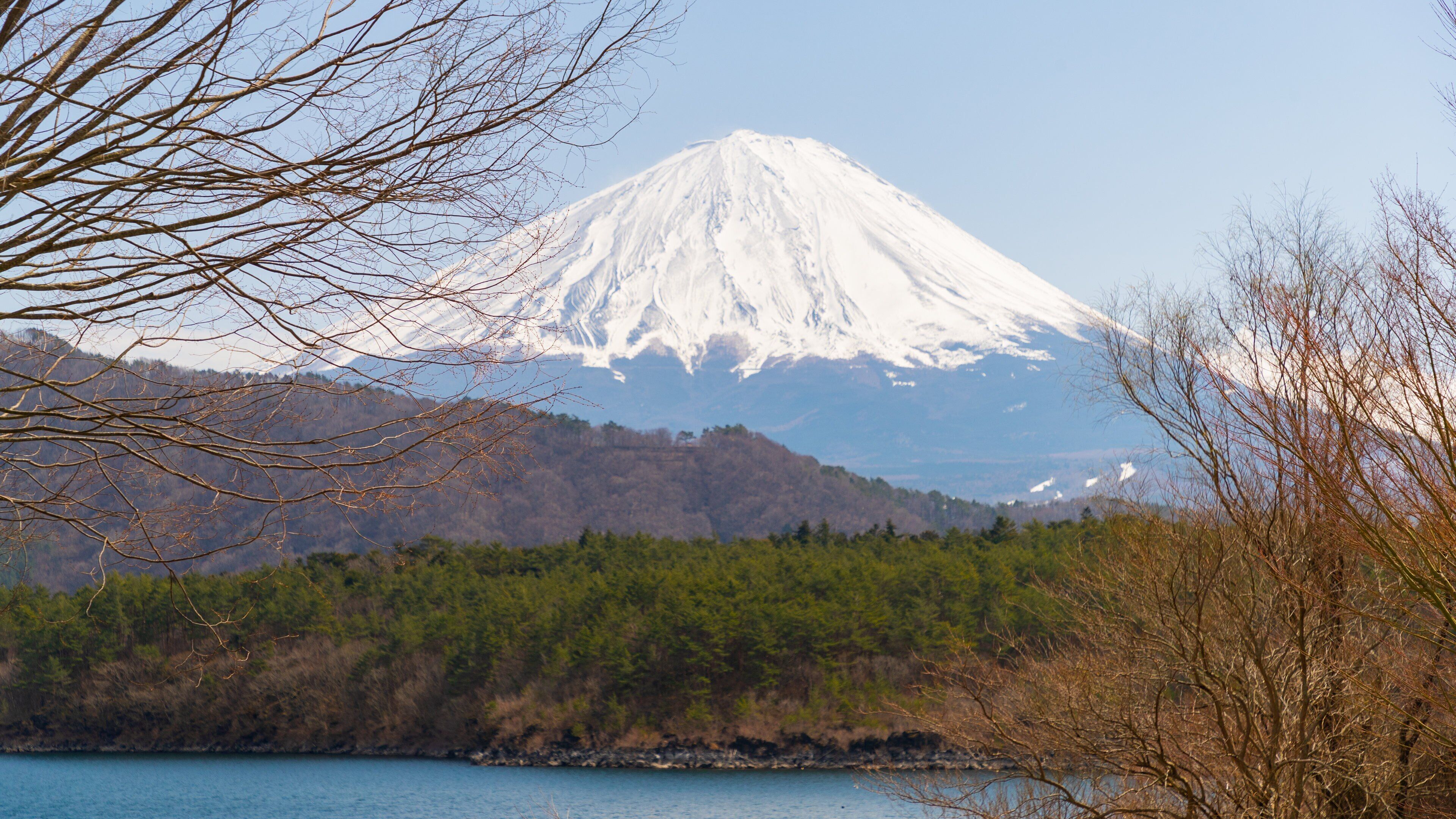 Lake Saiko showing mountains, snow and a lake or waterhole