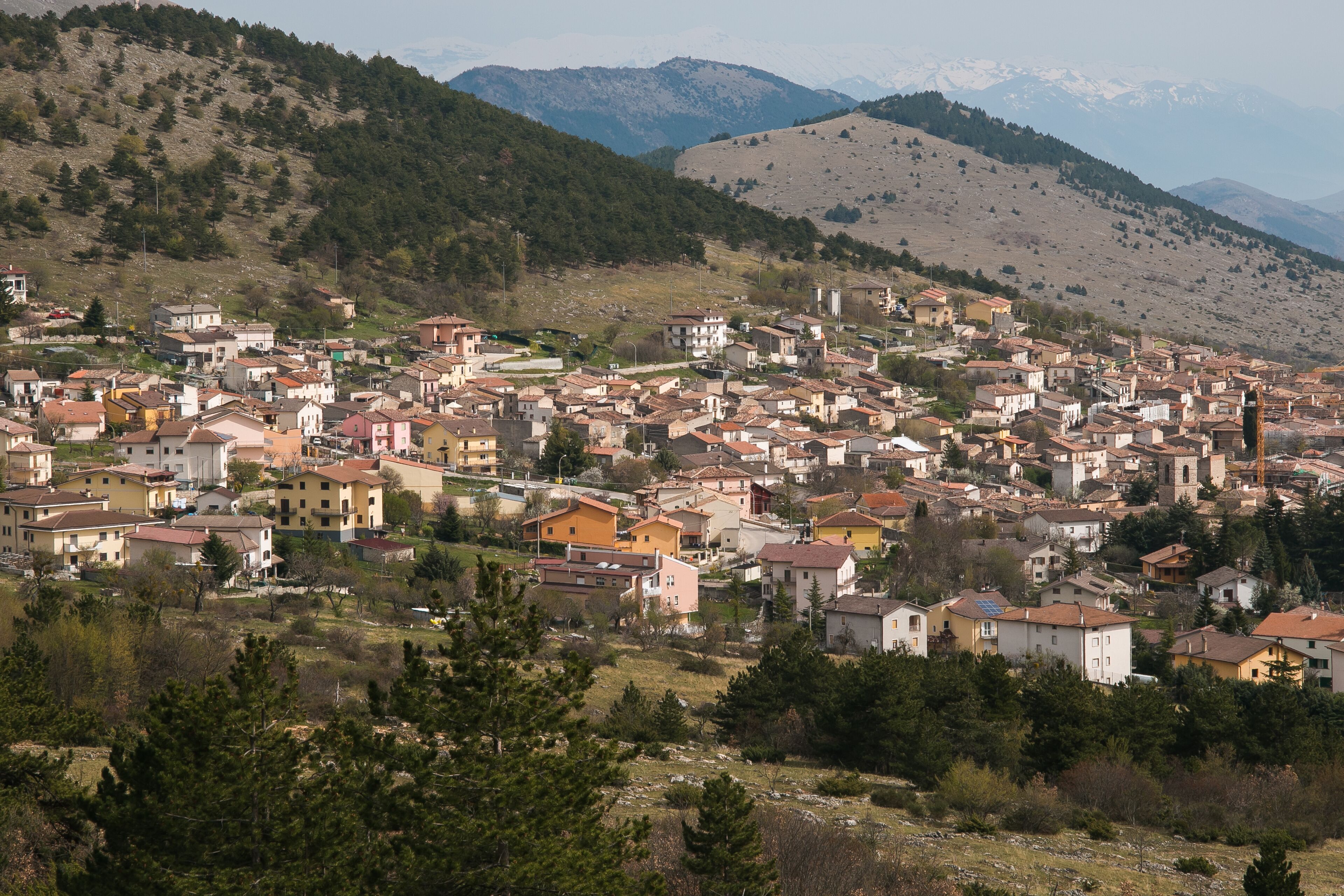 A town nestled in a valley with mountains in the background.