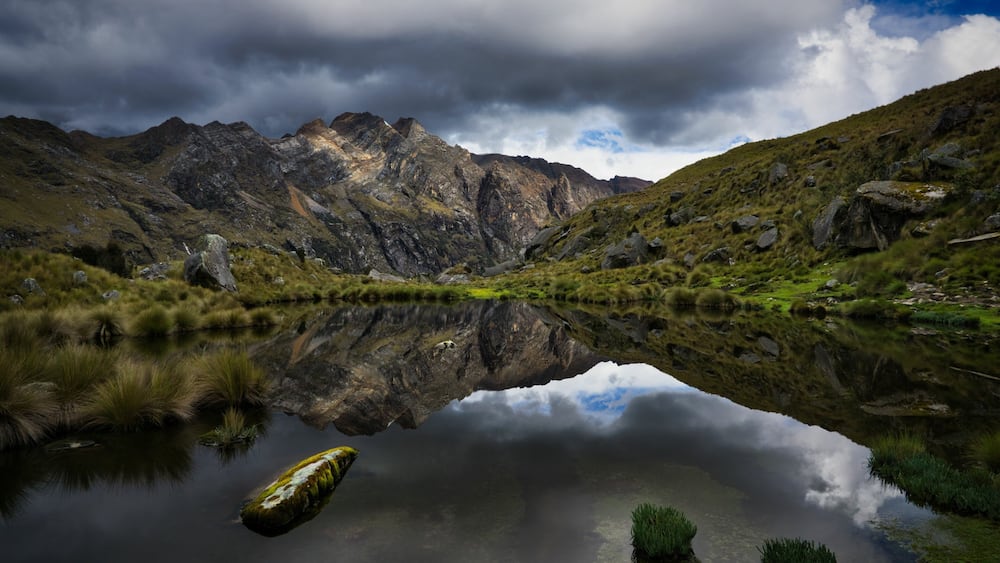Mountain landscape reflected in lake water surface in the Cordillera Blanca close to Huaraz, Peru. The picture of the lagoon was taken on the 4-day Santa Cruz trek in the Parque Nacional Huascarâ°n