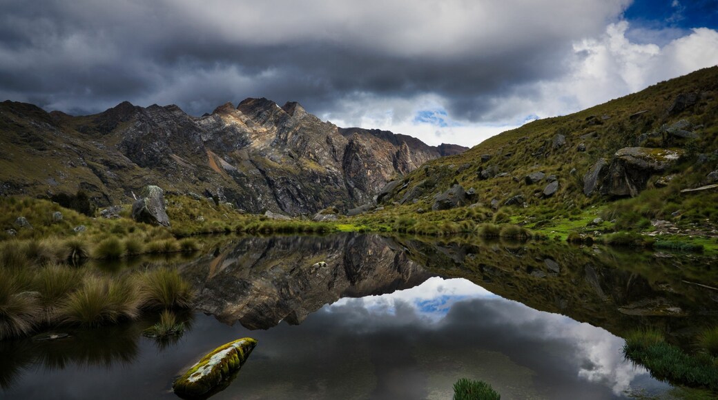 Mountain landscape reflected in lake water surface in the Cordillera Blanca close to Huaraz, Peru. The picture of the lagoon was taken on the 4-day Santa Cruz trek in the Parque Nacional Huascar√°n