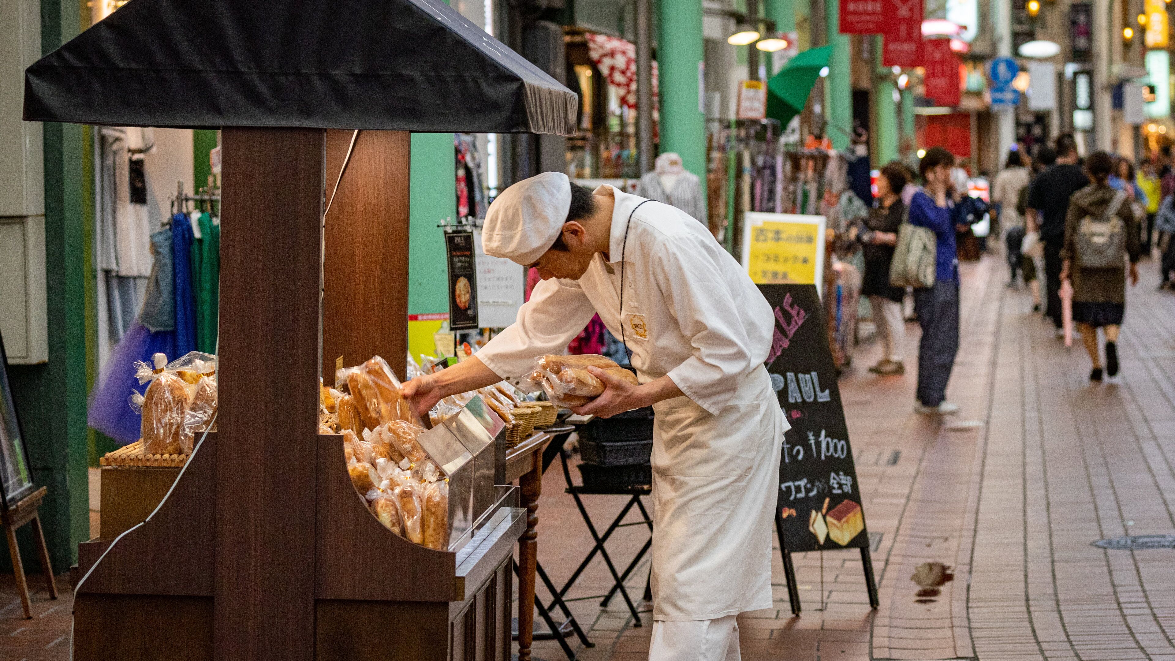 Motomachi Shopping Street which includes street scenes and markets as well as an individual male