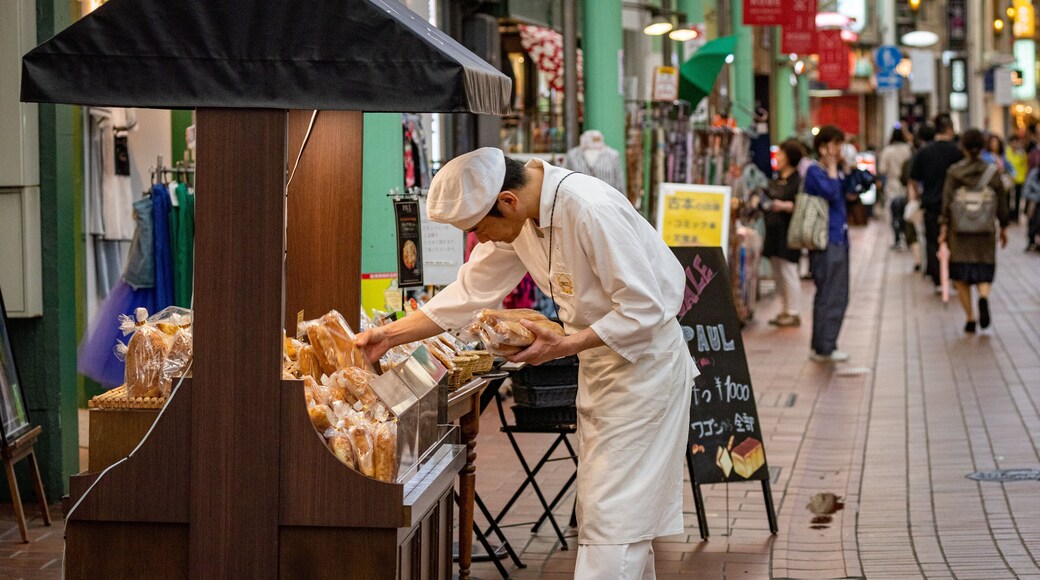 Motomachi Shopping Street which includes street scenes and markets as well as an individual male