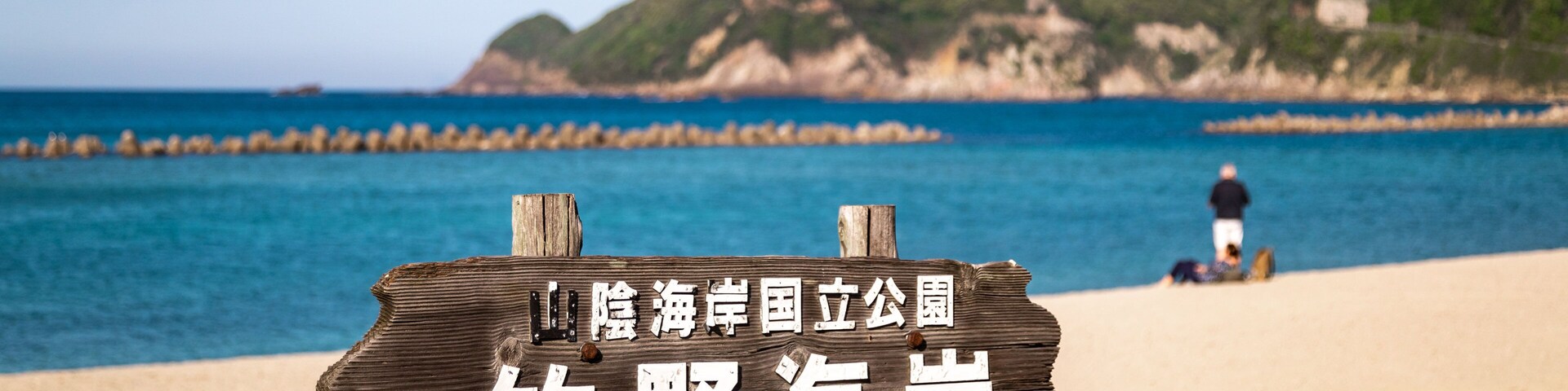 Takeno Beach featuring signage, general coastal views and a sandy beach
