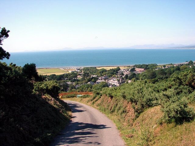 Lane down to Llwyngwril, near to Llwyngwril, Gwynedd, Wales. In the distance are the hills of the Lleyn Peninsula.