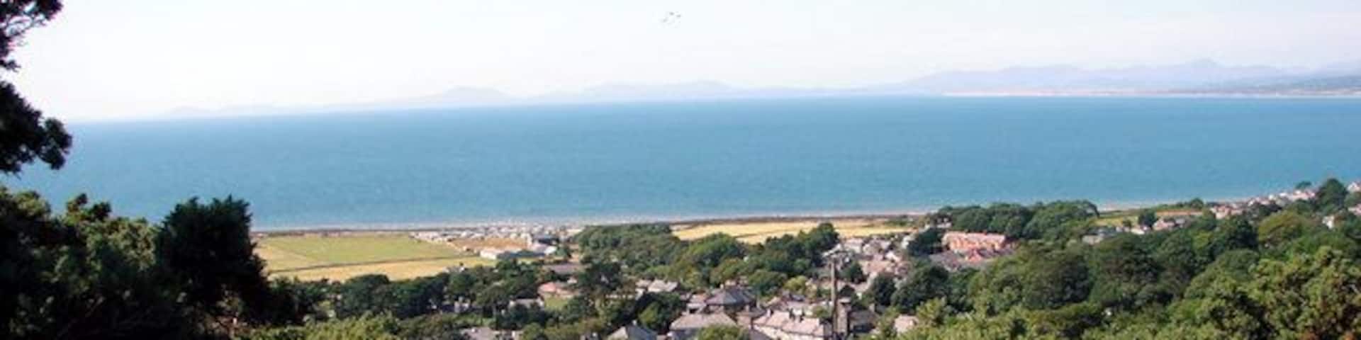 Lane down to Llwyngwril, near to Llwyngwril, Gwynedd, Wales. In the distance are the hills of the Lleyn Peninsula.