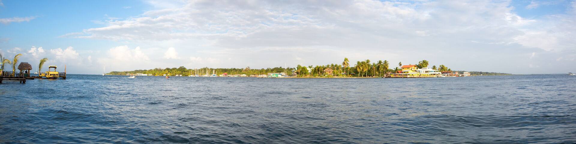 Colorful Caribbean buildings over the water with boats at dock
